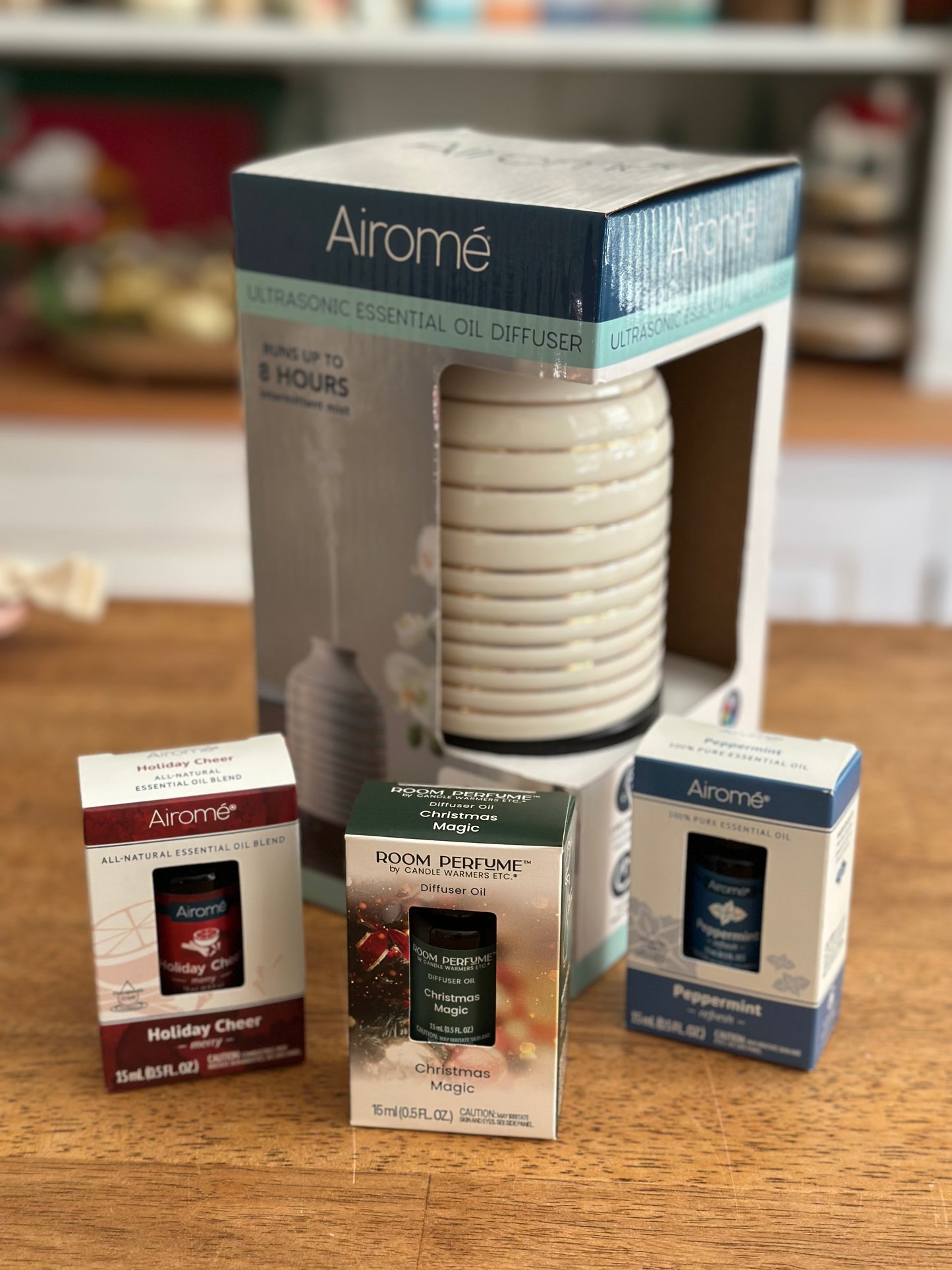 Airomé diffuser and essential oil packaging on a wooden surface