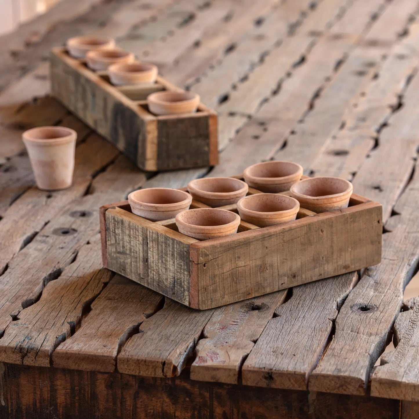 Rustic square terra cotta wood planter set with six small pots in a primitive wooden box. Ideal for tabletop decor, measuring 3'H x 9'L x 8'W.