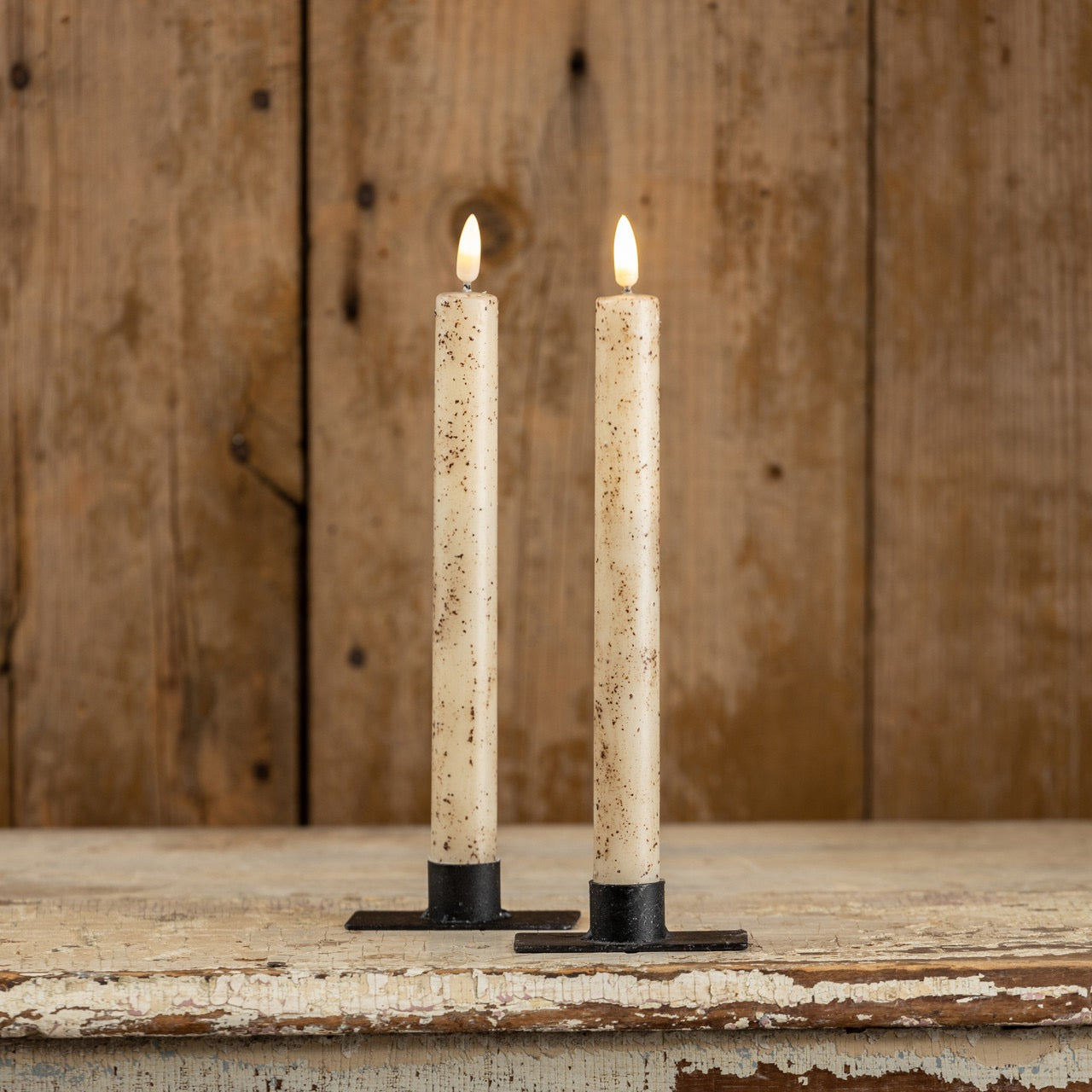 Set of two 9.5-inch cream taper candles with a realistic 3D flame effect. These flameless candles feature a rustic speckled design, perfect for home decor.