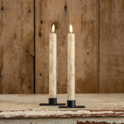 Set of two 9.5-inch cream taper candles with a realistic 3D flame effect. These flameless candles feature a rustic speckled design, perfect for home decor.