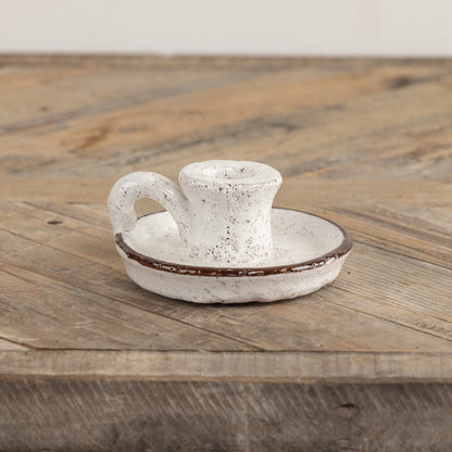 Brown and white terracotta taper candle holder with handle, featuring a speckled finish and classic design. Perfect for rustic or farmhouse décor.