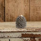 Moving Flame Pinecone Candle - 4.25" with a realistic flickering flame, featuring a textured pinecone design in a rustic setting.