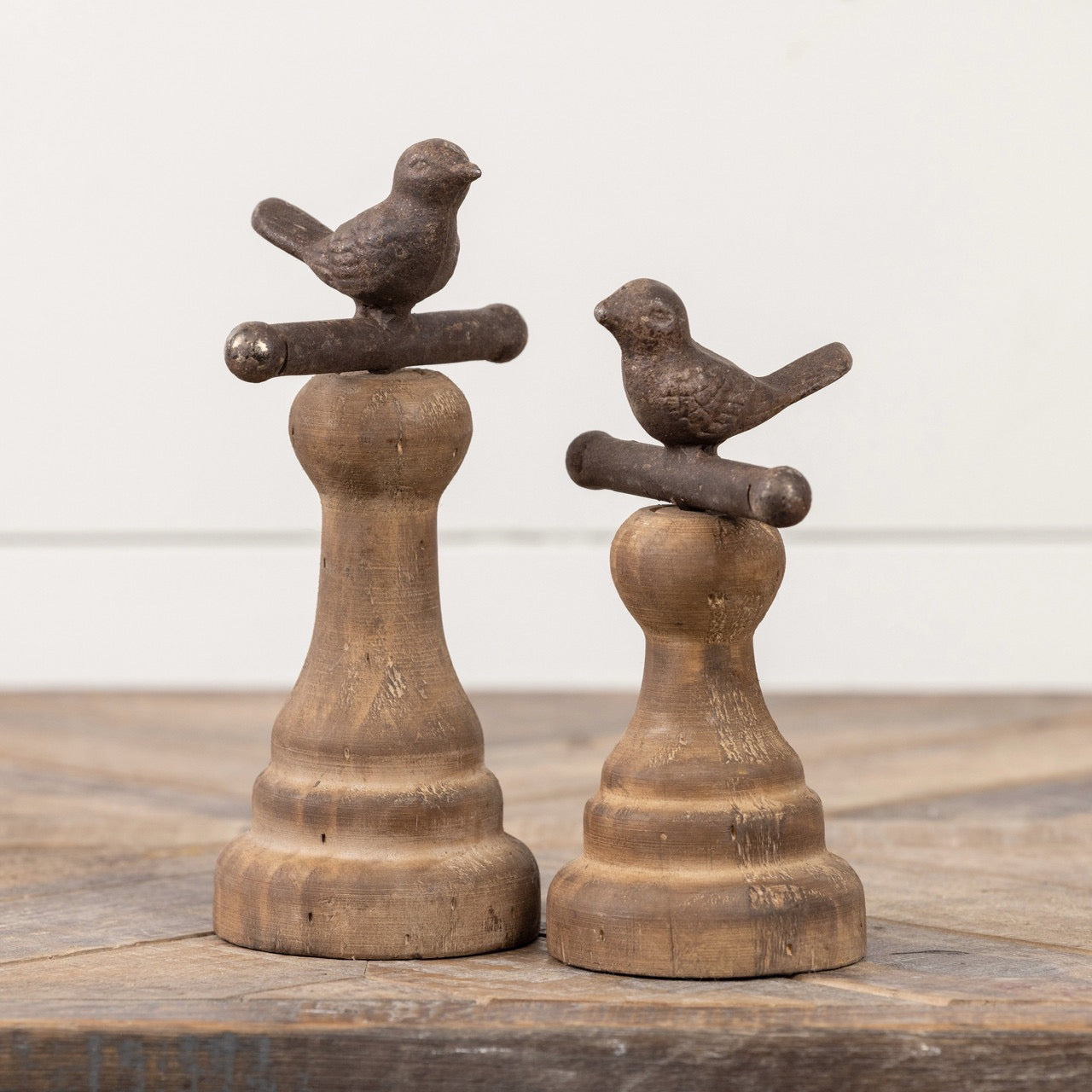 Set of two brown perching bird figurines on wooden pedestals, perfect for enhancing rustic and vintage home decor aesthetics.