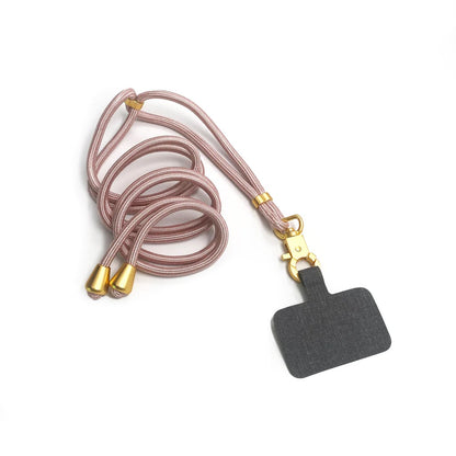 TECH CANDY HOOKUP lanyard in rose gold with gold accents, featuring a black attachment for securing mobile phones. Stylish and functional phone strap.
