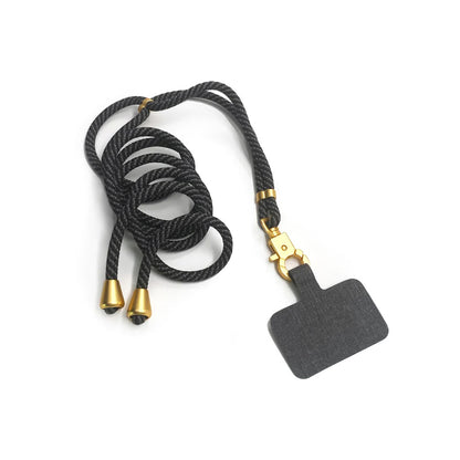 TECH CANDY HOOKUP lanyard in black with gold accents, designed with a secure black attachment for mobile phones. Elegant and practical phone accessory.