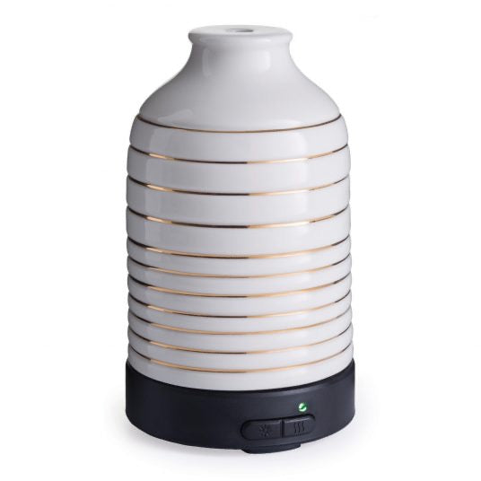 Serenity Ultra Sonic Diffuser with a sleek white ceramic design and gold accents, featuring a black base with control buttons for home fragrance.