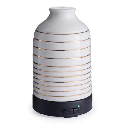 Serenity Ultra Sonic Diffuser with a sleek white ceramic design and gold accents, featuring a black base with control buttons for home fragrance.