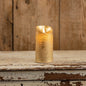Gold pillar candle with moving flame, 6-inch size, featuring a realistic flickering effect. Perfect for home decor with a rustic wooden background.