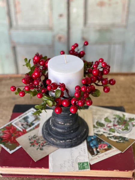 Black distressed Spence Holder 5-inch with a white candle and red berry wreath, adding a festive touch to rustic home decor settings.