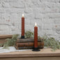 Set of 2 3D Flame Bronze Taper Candles, 7.25 inches tall, displayed on vintage books with greenery. Realistic flameless design for cozy ambiance.