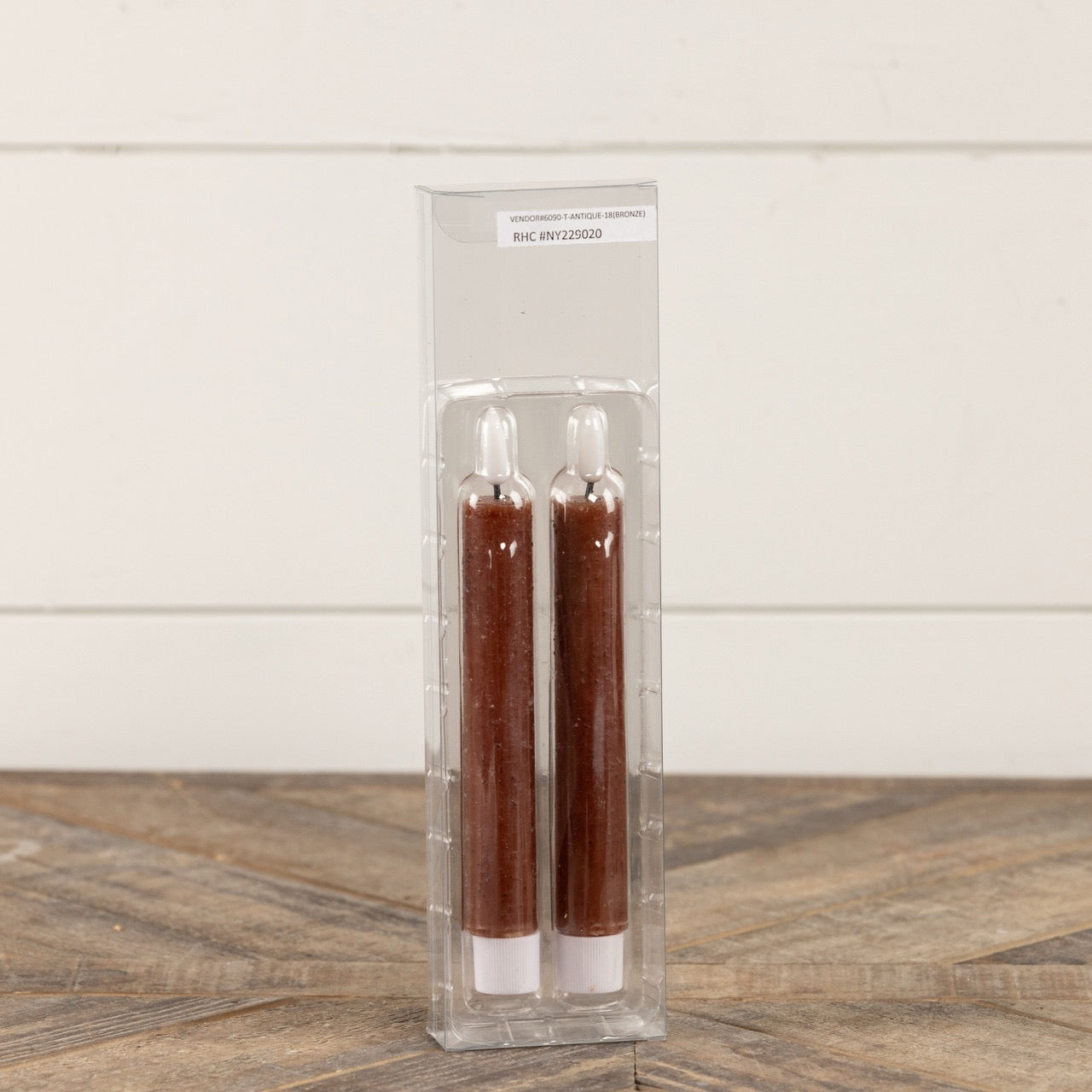 Packaged set of 2 3D Flame Bronze Taper Candles, 7.25 inches, in clear plastic casing. Safe, flameless candles for home decor and ambiance.